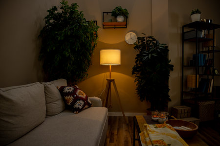 A Cozy Living Room that features Plants, Soft Textiles, and Warm Ambient Lightingの写真素材