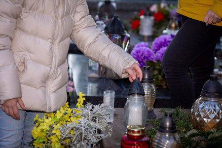 Candle Lighting Ceremony at a Cemetery for Remembering Loved Ones and Their Legacyの写真素材