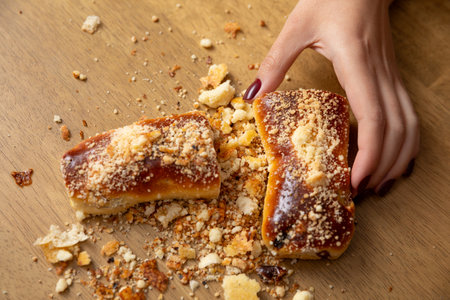 An Exquisite and Delicious Pastry with Crumbs Artfully Displayed on a Beautiful Wooden Table Surfaceの写真素材