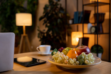 A Cozy and Inviting Living Room Featuring Fresh Seasonal Fruits and a Warm Cup of Coffeeの写真素材