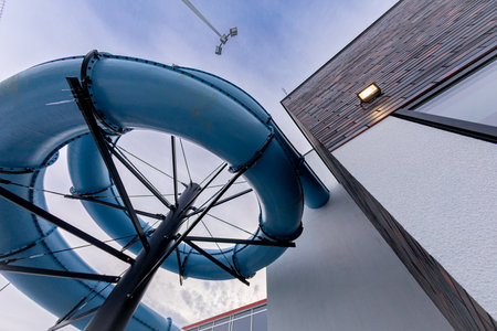 An eyecatching image of a twisting water slide from below, highlighting its vibrant colors