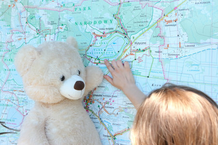 Embarking on an exciting journey of exploration with a cuddly teddy bear by your sideの写真素材