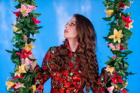 A Beautiful Woman Surrounded by Colorful Flowers Beautifully Set Against a Blue Background