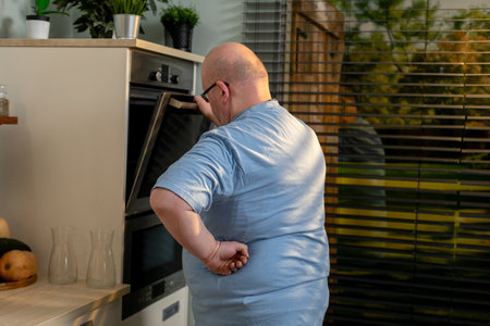 A Man Engaged in Cooking Within a Modern Kitchen Setting A Memorable Culinary Experienceの写真素材
