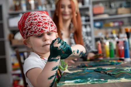 A Creative Child Engaged in Playful Painting Activities Inside an Art Studio Environmentの写真素材