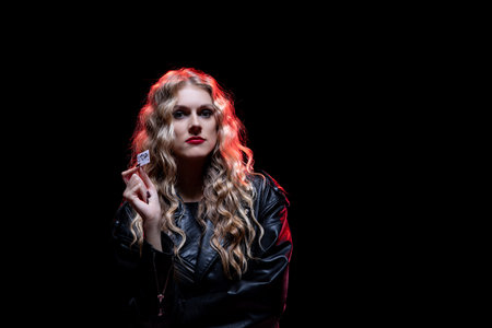 A Glamorous Portrait of a Woman Captured Against a Rich, Dark Background Settingの写真素材