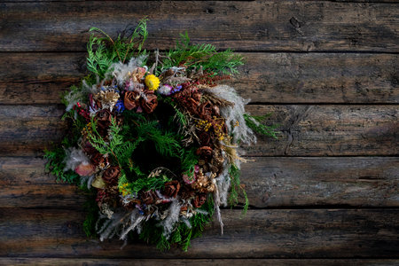 Beautiful Natural Rustic Wreath Decor Graced on a Charming Wooden Background Surfaceの写真素材