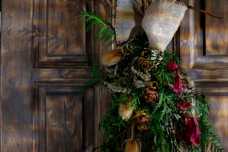 Discover the beauty of Rustic Greenery Decor with Dried Flowers on a Wooden Backgroundの写真素材