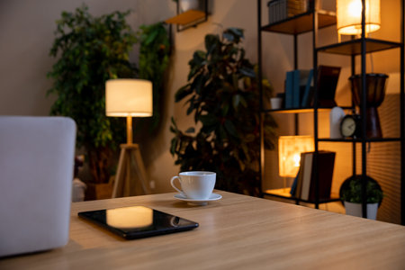Design a Cozy Home Office with Modern Decor and Warm Lighting for an inviting atmosphereの写真素材
