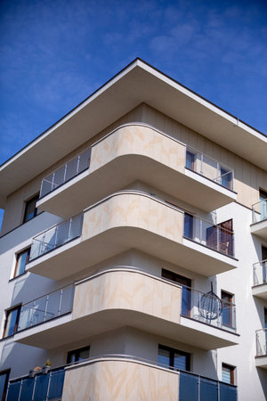 This is a modern apartment building featuring stylish balconies and clean, sleek linesの写真素材