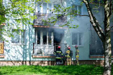 Firefighters are bravely battling a major residential blaze in an urban area, showing skillの写真素材