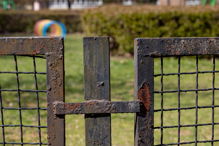 A Rusty Garden Gate set amid a lush Grassy Background, invoking charm and tranquility in natureの写真素材
