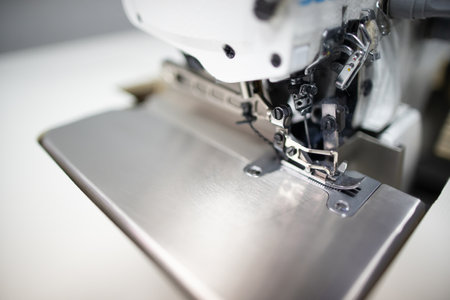 A detailed closeup view of a Sewing Machine Needle combined with the Presser Foot componentの写真素材
