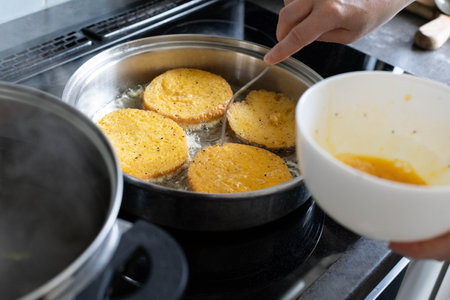 A crispy cooking scene displays golden pancakes with sauce preparation, showcasing a masterpieceの写真素材