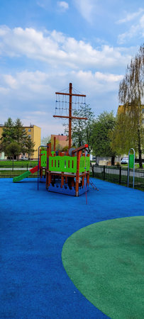 A Colorful Playground Featuring a Pirate Ship Structure Located in an Urban Park Setting