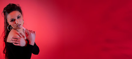 An Impressive and Stylish Portrait Featuring a Striking Red Background and Dramatic Lighting Effectsの写真素材