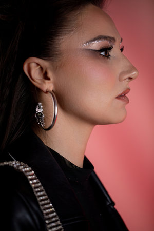 Chic and Stylish Profile Portrait of a Fashionable Young Woman with an Elegant Touchの写真素材