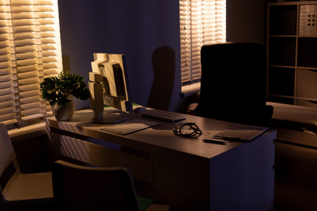 A Cozy Evening Office Scene Featuring Soft Lighting, Lush Plants, and a Welcoming Ambiance