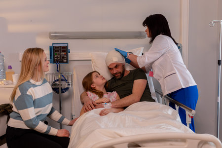 A devoted family supporting their beloved member in a hospital room during recovery and healingの写真素材