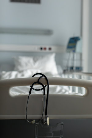 A Hospital Scene featuring a Stethoscope and a Patient Bed within a Medical Settingの写真素材