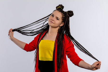 A Stylish Young Woman with Beautifully Braided Hair in a Variety of Bright Colors