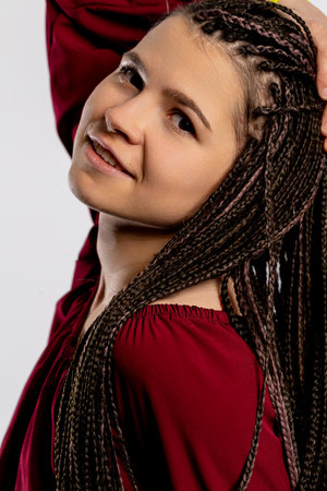 A Young Woman with Beautifully Braided Hair Dressed in a Vibrant and Eyecatching Red Top