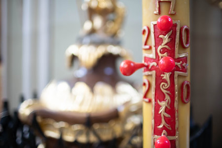 This is a Decorative Candle featuring an Intricate Design that includes a Cross motif