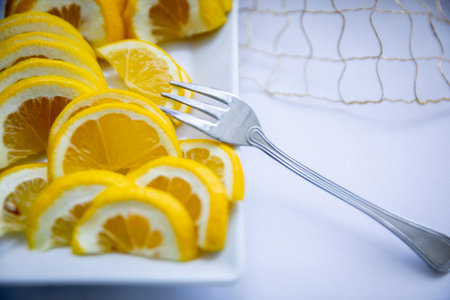 Vibrant and Fresh Lemon Slices Beautifully Served on an Elegant Plate for Enjoymentの写真素材