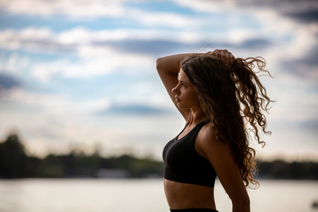 Stylized Silhouette of a Beautiful Woman with Curly Hair Against a Calm and Serene Background