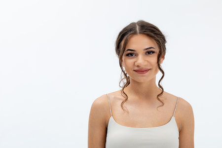 A captivating portrait of a young woman, illuminated softly to highlight her beauty and confidenceの写真素材