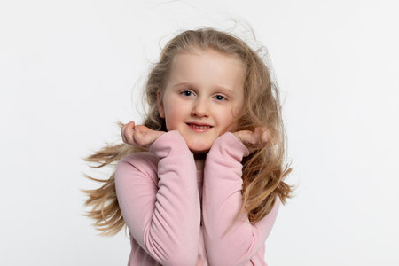 A Cheerful Happy Child Smiling Brightly While in a Playful and Joyful Pose, Radiating Happiness