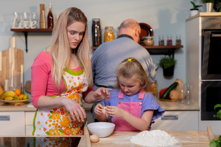 A Family Cooking Together in a Bright, Inviting Kitchen Filled with Joy and Loveの写真素材