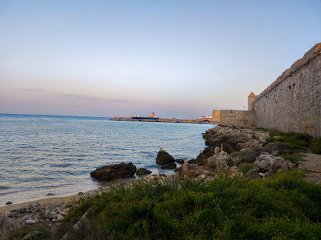 A Serene Coastal View featuring a Historic Stone Wall at Dusk, perfect for relaxing escapades