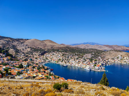 Experience the Breathtaking Coastal View Overlooking the Serene Harbor and Charming Village