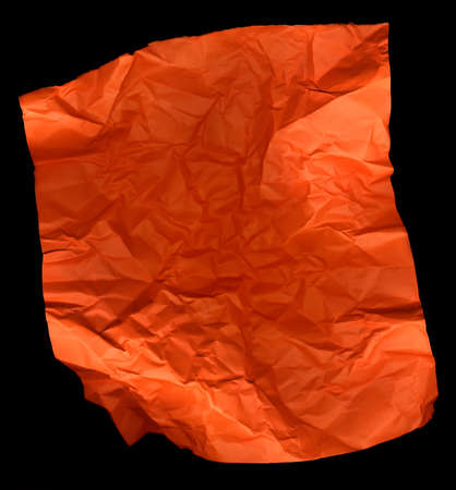 Creased Sheet of Orange Paper Isolated on Black Backgroundの写真素材