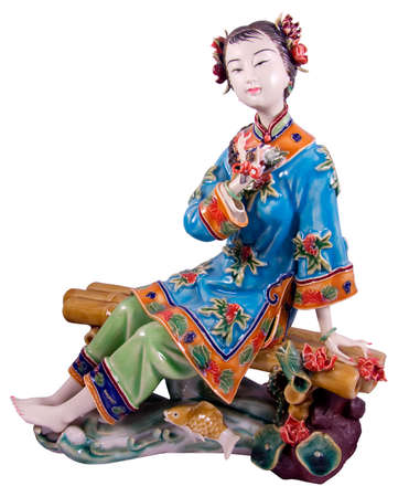 Porcelain statue of a china woman sitting on a benchの写真素材