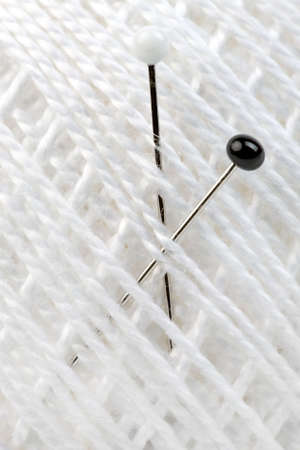 Macro shot of tailors pin embed in cottonの写真素材