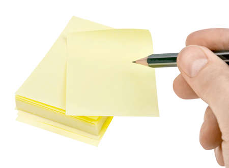 Human hand with pencil write on yellow memories sticker.