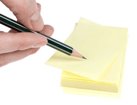 Human hand with pencil write on yellow memories sticker. path.