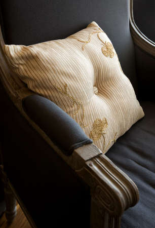 Ornate stripped pillow on the old stile armchairの写真素材