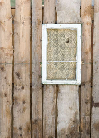 Old boarded pine wall with white windowの写真素材