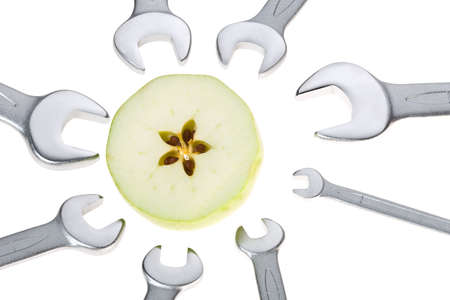 Cut apple and wrench isolated.の写真素材