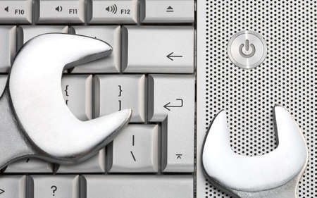 Two metal spanners on the laptop keyboardの写真素材