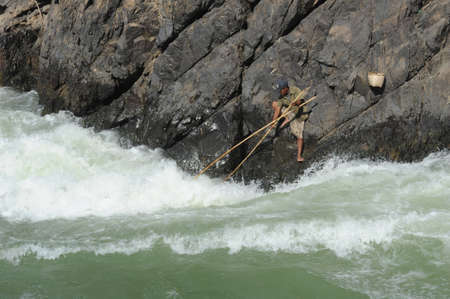 Fisherman at Tat Somphamit waterfall at Kon Khon on Laos