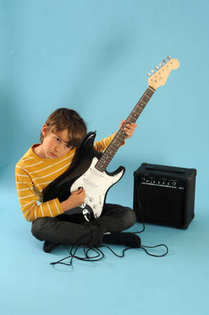 Boy playing a electric guitarの写真素材