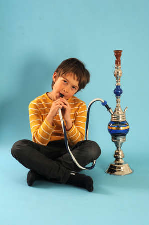 Boy smoking a water pipe