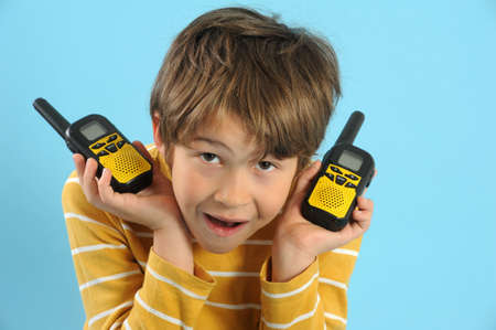 Boy talking with a walkie talkieの写真素材