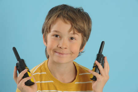 Boy talking with a walkie talkieの写真素材