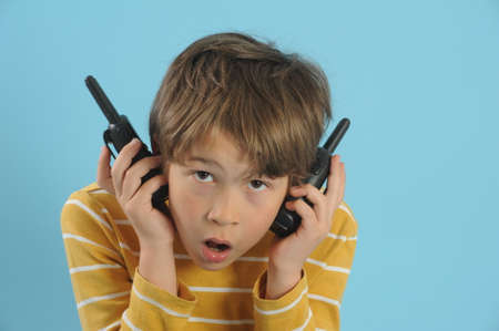 Boy talking with a walkie talkieの写真素材