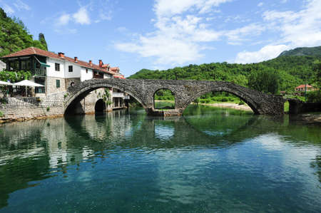 The old arched stone bridge of Rijeka Crnojevica on Montenegroの写真素材